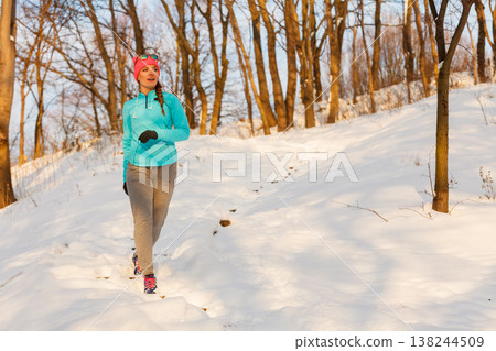 Woman doing winter jog in morning Woman doing winter jog in morning 138244509