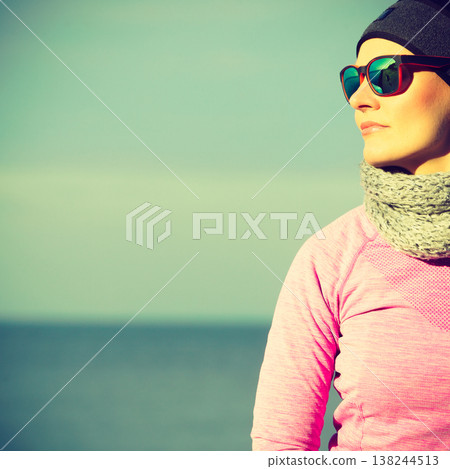 Woman resting after doing sports outdoors on cold day Woman resting after doing sports outdoors on cold day 138244513
