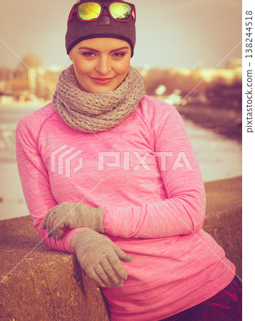 Woman resting after doing sports outdoors on cold day Woman resting after doing sports outdoors on cold day 138244518