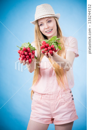 Young woman holding radish Young woman holding radish 138244552