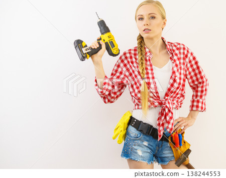 Woman aiming with drill 138244553