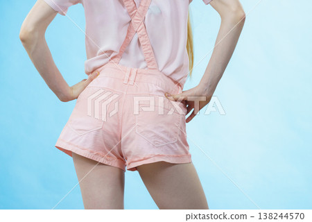 Woman in dungarees back view 138244570