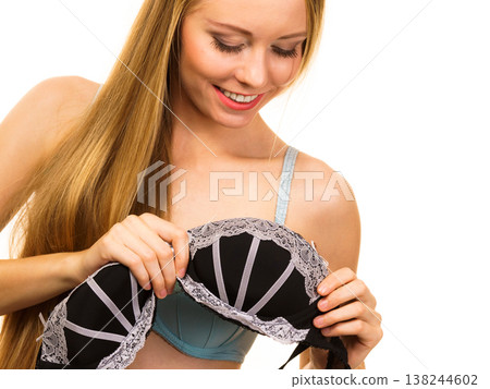 Woman trying on black bra with lace 138244602