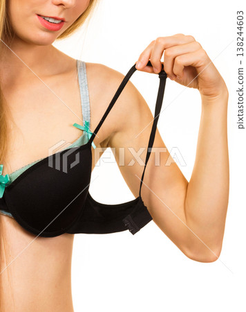 Woman trying on black pushup bra Woman trying on black pushup bra 138244603