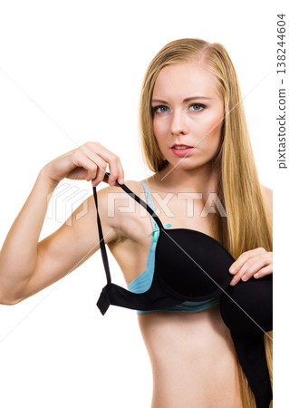 Woman trying on black bra Woman trying on black bra 138244604