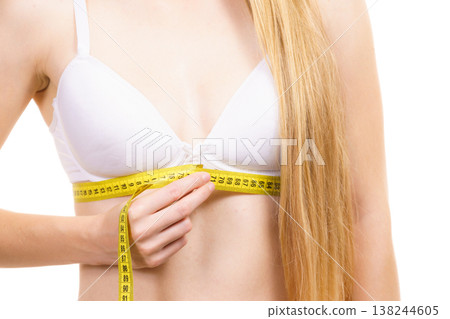 Woman measuring her chest under breast Woman measuring her chest under breast 138244605