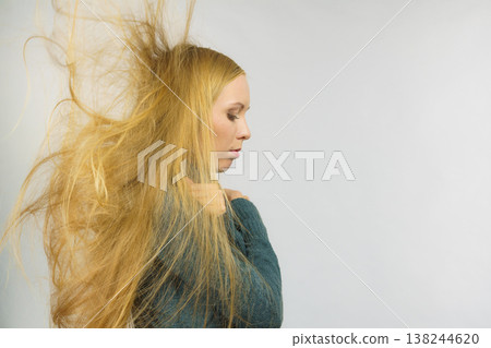 Sad girl with blowing hair Sad girl with blowing hair 138244620