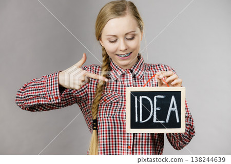 Happy positive woman holding idea sign Happy positive woman holding idea sign 138244639