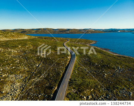 Road crossing Hardangervidda plateau, Norway. Aerial view. Road crossing Hardangervidda plateau, Norway. Aerial view. 138244734