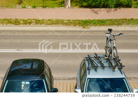 Car with bicycle mounted to the roof rack 138244739
