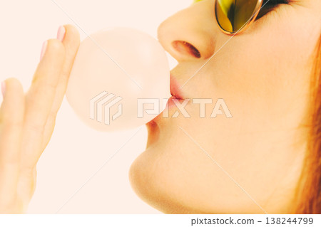 Funky girl blowing balloon. Funky girl blowing balloon. 138244799
