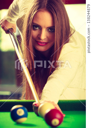 Young fashionable girl playing billiard. 138244879