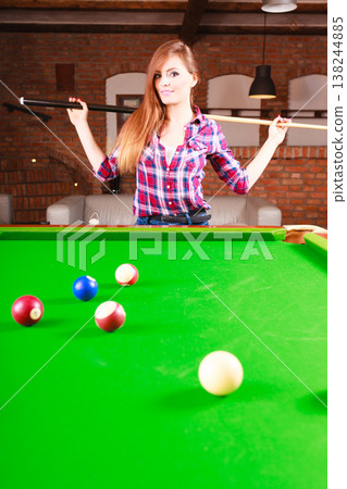 Young woman having fun with billiard. 138244885