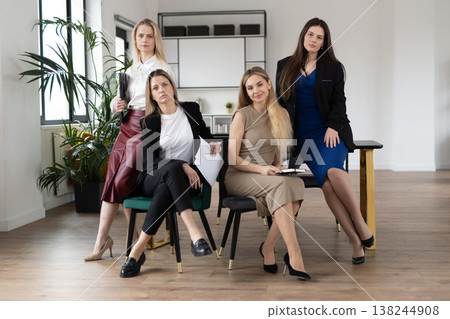 Professional women collaborating, showcasing leadership, teamwork, and empowerment in a contemporary office setting, representing diversity and success in a female driven business environment Professional women collaborating, showcasing leadership, teamwork, and empowerment in a contemporary office setting, representing diversity and success in a female driven business environment 138244908