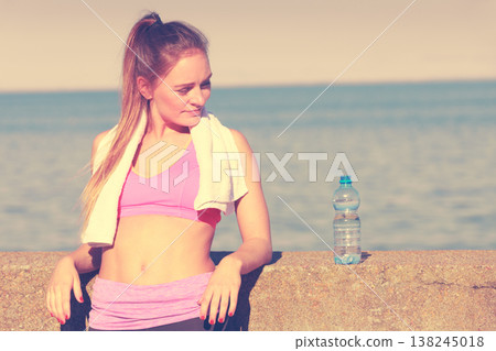 Woman drinking water after sport gym outdoor 138245018