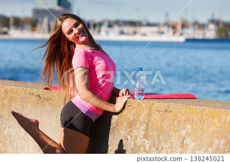 Woman drinking water after sport gym outdoor Woman drinking water after sport gym outdoor 138245021