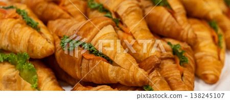 Fresh Baked Croissants . A pile of tasty crispy croissant on restaurant buffet 138245107