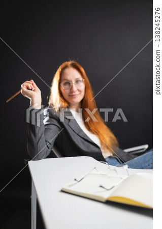 Woman freelancer holding pencil smiling at camera Woman freelancer holding pencil smiling at camera 138245276