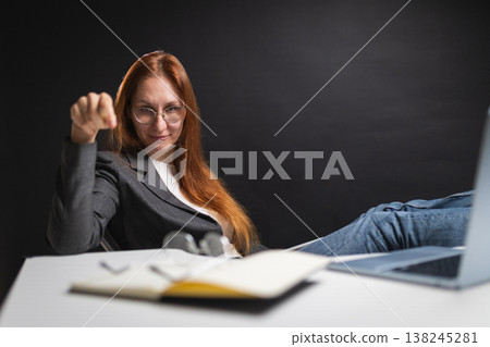 Confident boss woman gesturing with hand at desk Confident boss woman gesturing with hand at desk 138245281
