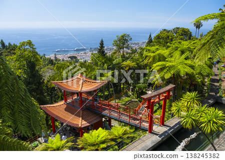 Monte Palace tropical garden with red pagoda, lakes and traditional buildings above the city of Funchal, popular tourist destination in Madeira island, Portugal Monte Palace tropical garden with red pagoda, lakes and traditional buildings above the city of Funchal, popular tourist destination in Madeira island, Portugal 138245382