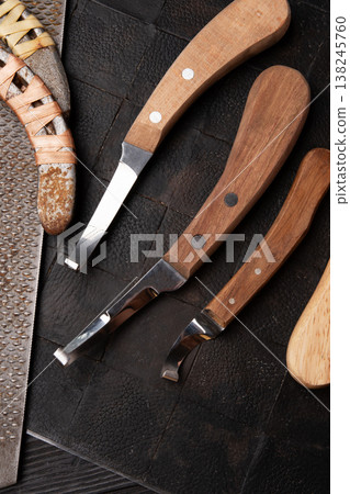 new professional hoof  knives with  rasp for trimming horsy foot at black background. horse hoof care concept 138245760