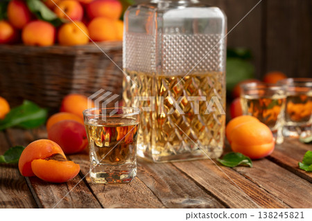 Apricot liqueur or grappa and fresh apricots. 138245821