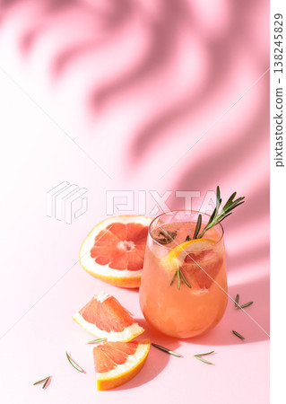 Summer cocktail with grapefruit, rosemary, and ice. 138245829