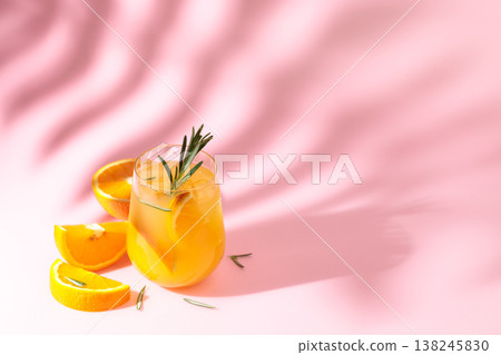 Summer cocktail with orange, rosemary, and ice. 138245830