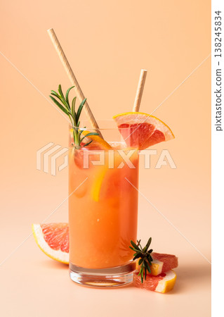 Summer cocktail with grapefruit, rosemary, and ice. 138245834