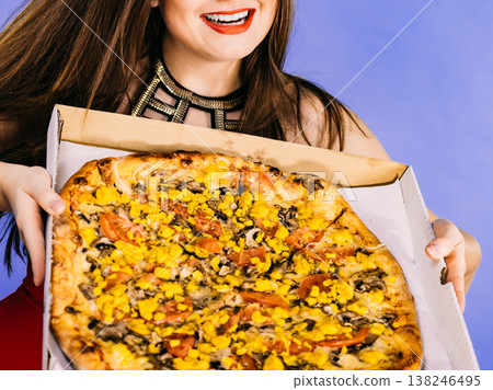 Woman holding big pizza in box Woman holding big pizza in box 138246495