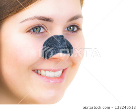 Woman applying pore strips on nose Woman applying pore strips on nose 138246518