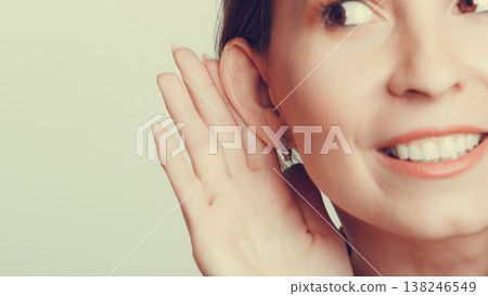 Gossip girl eavesdropping with hand to ear. Gossip girl eavesdropping with hand to ear. 138246549
