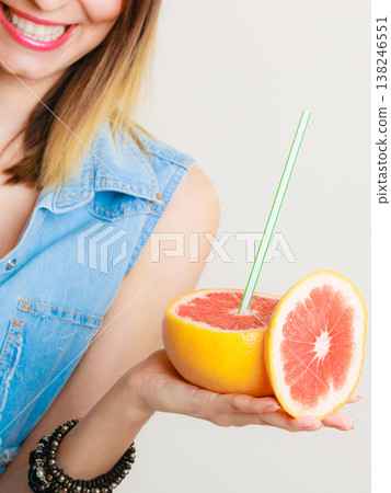Summer girl tourist holding grapefruit citrus fruit Summer girl tourist holding grapefruit citrus fruit 138246551