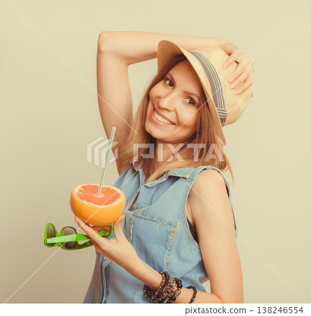 Happy woman in hat drinking grapefruit juice. Diet 138246554
