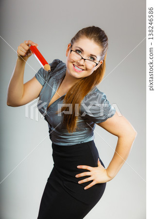 Teacher looking elegant woman holding big pencil Teacher looking elegant woman holding big pencil 138246586
