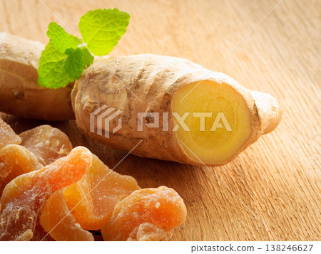Closeup root and candied ginger on wooden table Closeup root and candied ginger on wooden table 138246627
