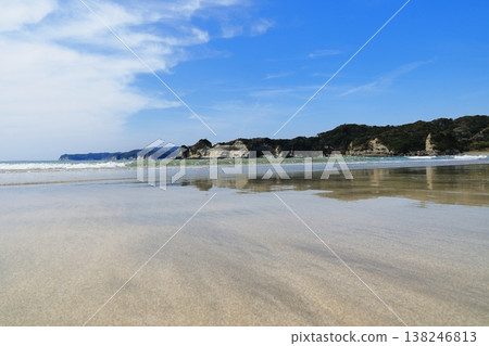 The shallow coastline at low tide and mountains visible in the distance. The shallow coastline at low tide and mountains visible in the distance. 138246813