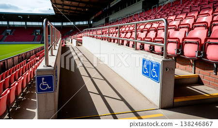 Accessible seating area ramp with wheelchair symbols at a sports stadium 138246867