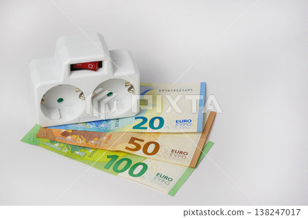Power strip on euro banknotes showing increasing energy costs Power strip on euro banknotes showing increasing energy costs 138247017