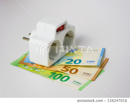Power strip on euro banknotes showing increasing energy costs Power strip on euro banknotes showing increasing energy costs 138247018