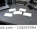 Workspace with blank business cards on desk. Corporate branding mockup with laptop. Clean template for identity, marketing and print design. AI generated image. 138247084