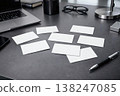Workspace with blank business cards on desk. Corporate branding mockup with laptop. Clean template for identity, marketing and print design. AI generated image. 138247085