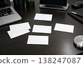 Workspace with blank business cards on desk. Corporate branding mockup with laptop. Clean template for identity, marketing and print design. AI generated image. 138247087