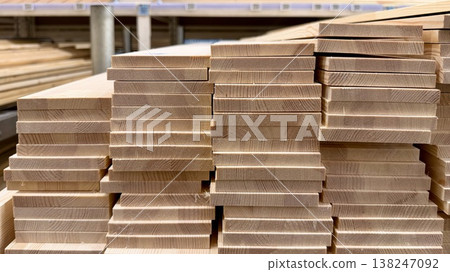 Stack of wooden boards in hardware store. Natural timber material background. Stack of wooden boards in hardware store. Natural timber material background. 138247092