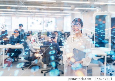 A woman smiling while holding documents in the office A woman smiling while holding documents in the office 138247481