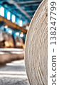 Industrial roller machine in paper mill with large paper roll and factory interior background 138247799