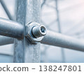 Close-up of metallic bolt and nut on power tower structure for energy infrastructure 138247801