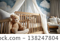 Wooden crib with teddy bear in nursery interior featuring cloud-themed wall decor and soft furnishings 138247804