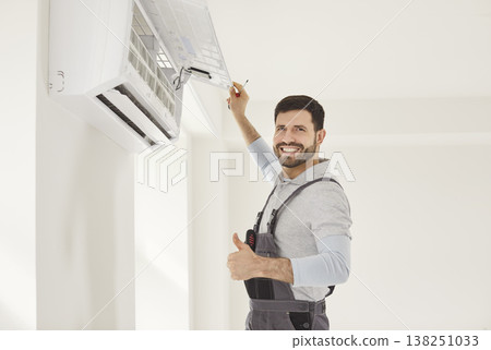 Service man working on wall mounted air conditioner unit, professional man smiling thumbs up gesture Service man working on wall mounted air conditioner unit, professional man smiling thumbs up gesture 138251033