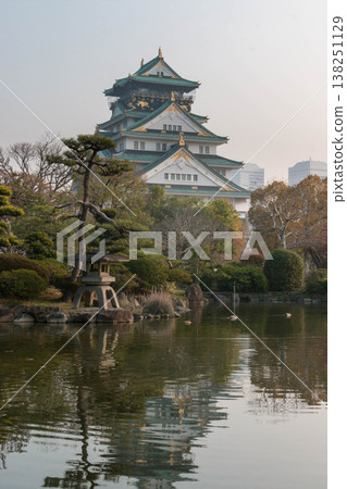 Osaka Castle Tower and Japanese Garden illuminated by the morning sun Osaka Castle Tower and Japanese Garden illuminated by the morning sun 138251129